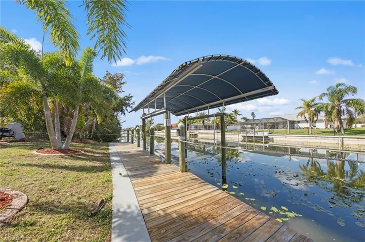 Dock with boat lift and a water view