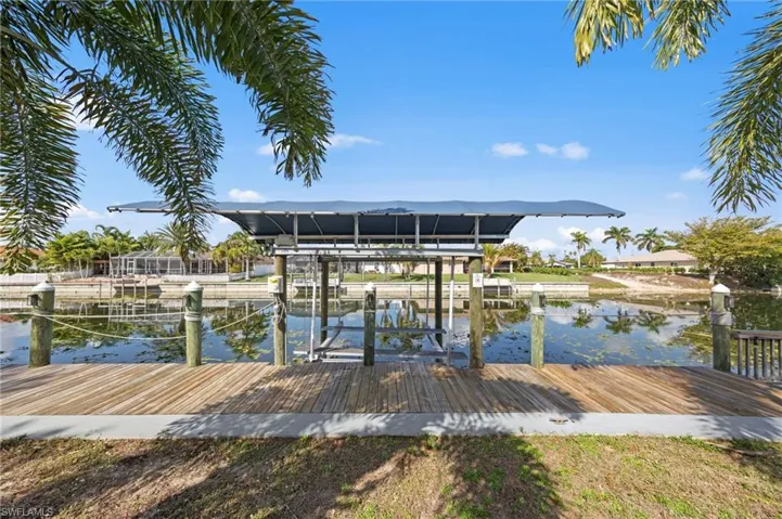 Dock with boat lift and a water view