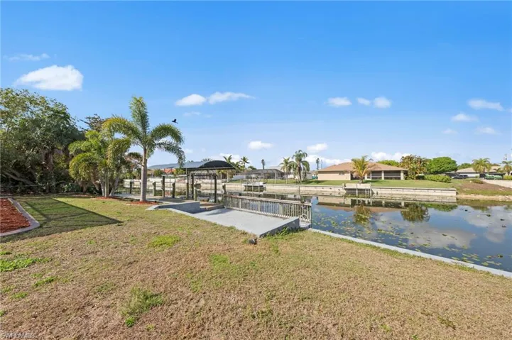 Dock with a yard and a water view