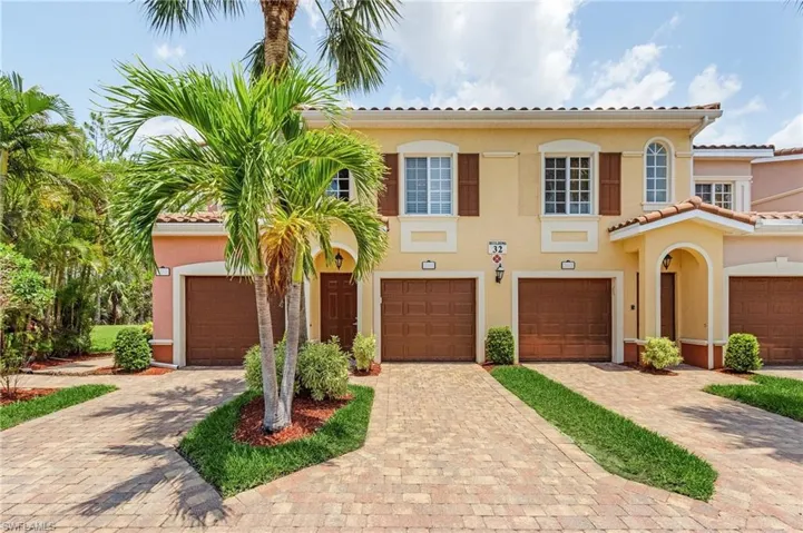 Mediterranean / spanish house with driveway, stucco siding, and a tile roof