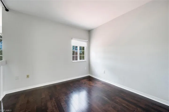Unfurnished room featuring dark wood finished floors
