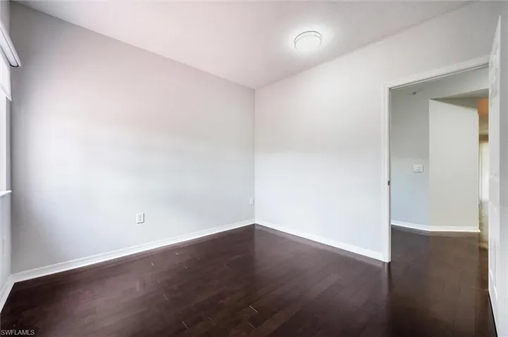 Empty room featuring dark wood-style floors