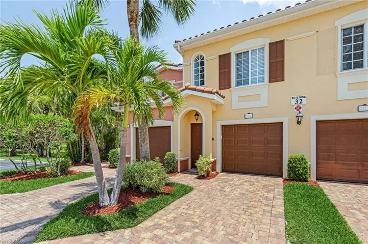 Mediterranean / spanish house featuring a garage, driveway, and stucco siding