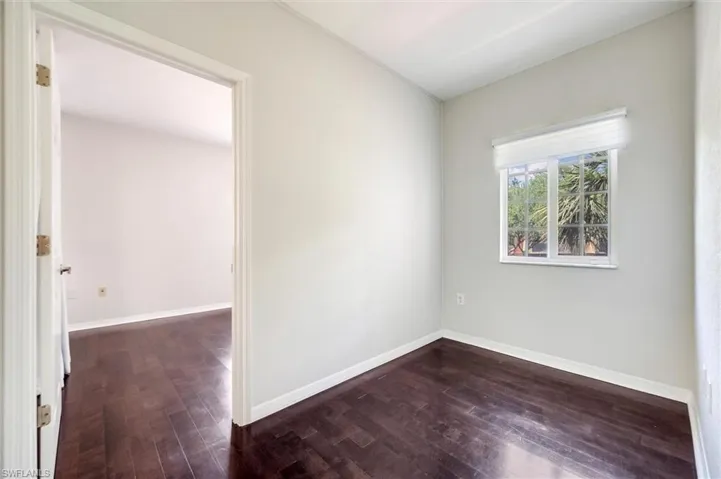 Empty room with dark wood-style floors