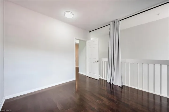 Spare room featuring wood finished floors and baseboards