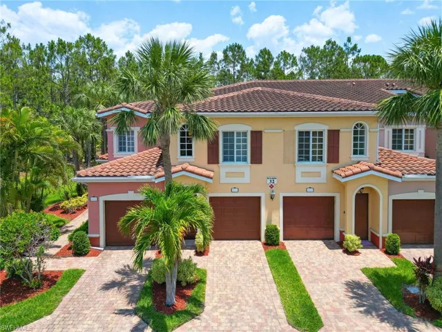 Mediterranean / spanish-style home featuring a tiled roof, driveway, stucco siding, and an attached garage