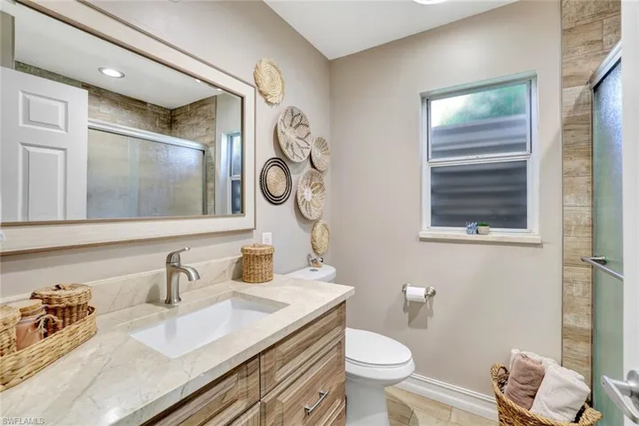 Bathroom with vanity and a shower with shower door