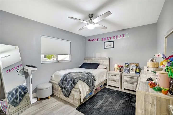 Bedroom featuring wood finished floors and a ceiling fan