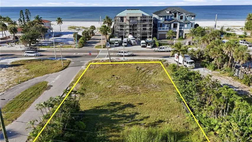 Aerial view of property's location with property boundaries highlighted and extended coastline - Virtually Edited Image