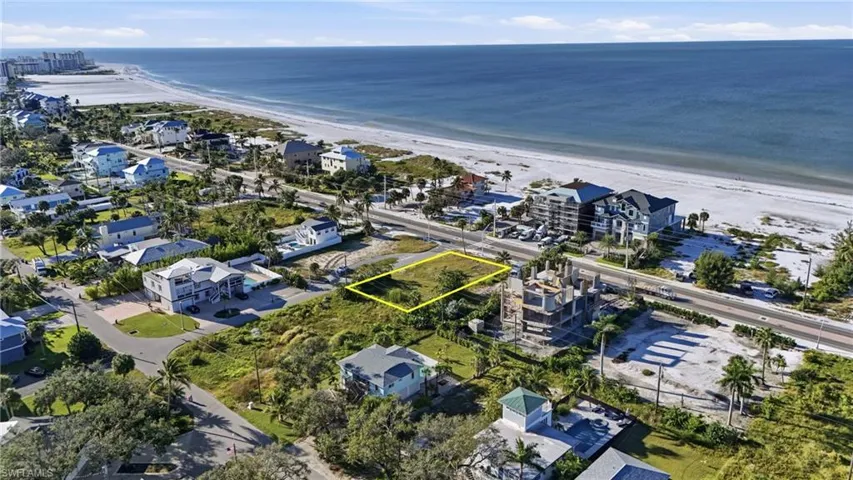 Aerial perspective of suburban area with property boundaries highlighted and expansive coastline - Virtually Edited Image
