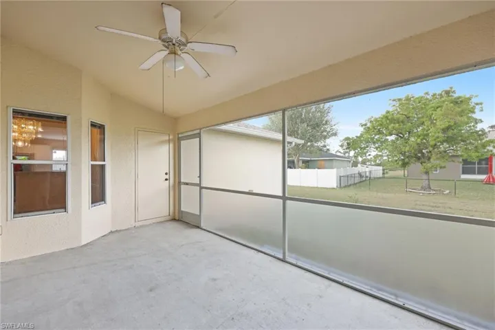 Unfurnished sunroom featuring ceiling fan and vaulted ceiling
