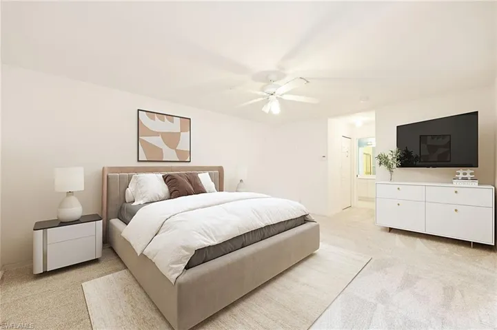 Carpeted bedroom featuring ceiling fan