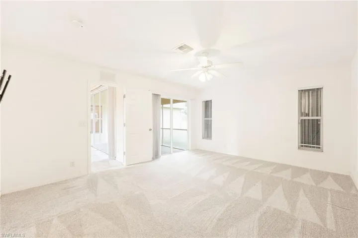 Spare room featuring light colored carpet and ceiling fan