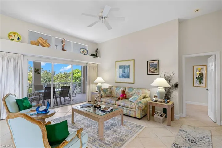 Living area featuring light tile patterned floors and ceiling fan