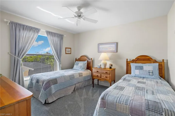 Carpeted bedroom with ceiling fan