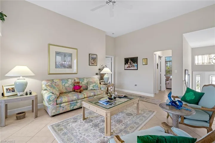 Living area with light tile patterned flooring and a ceiling fan