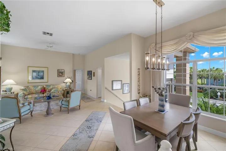 Dining area featuring light tile patterned flooring and a chandelier