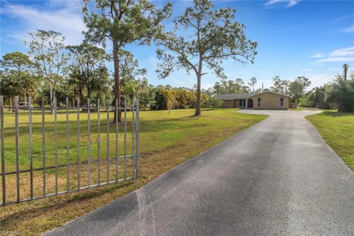 View of front of house featuring a front yard and aphalt driveway