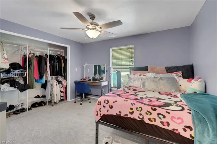 Bedroom with a closet, a ceiling fan, and carpet floors