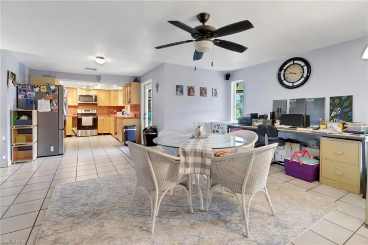 Dining area with light tile patterned floors and a ceiling fan