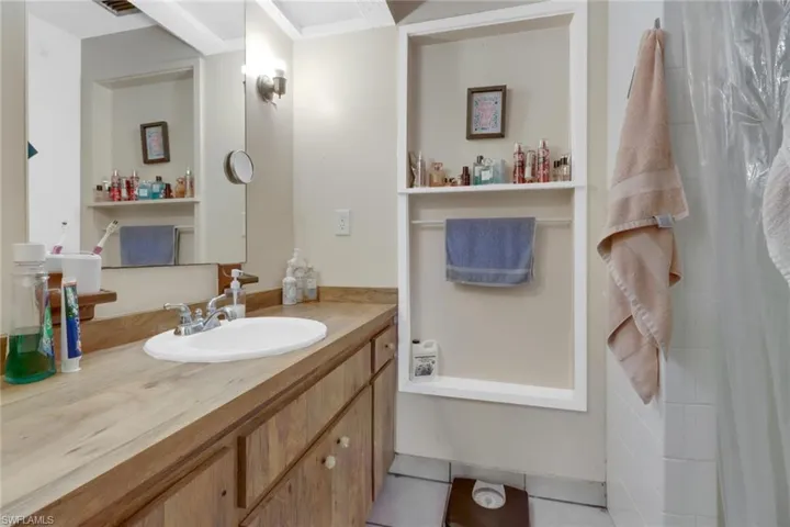 Bathroom featuring tile patterned flooring, vanity, and visible vents