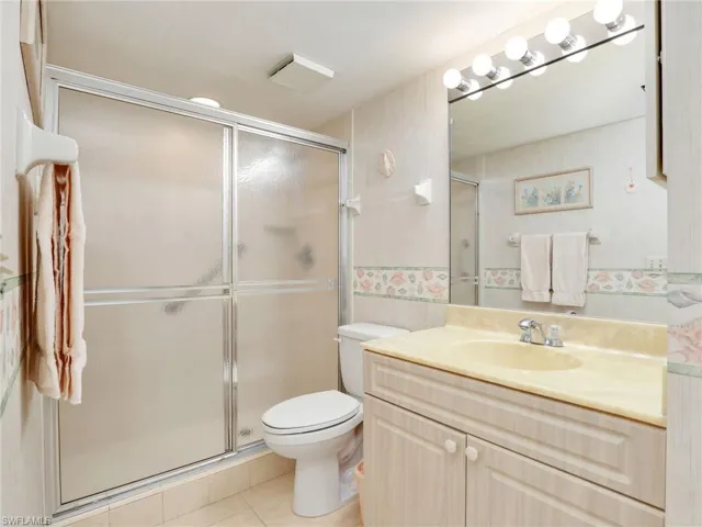 Second Bathroom with Tiled Shower with Glass Sliding Doors