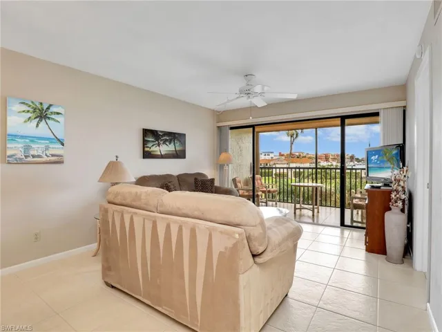 Living Room with Sliders to the Screened In Lanai with New Hurricane Shutters and Bay View
