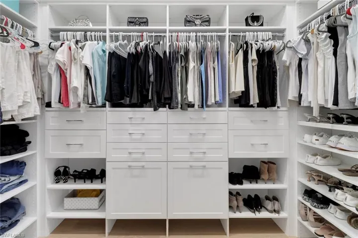 One of two walk in closets in primary suite with spacious closet organizers