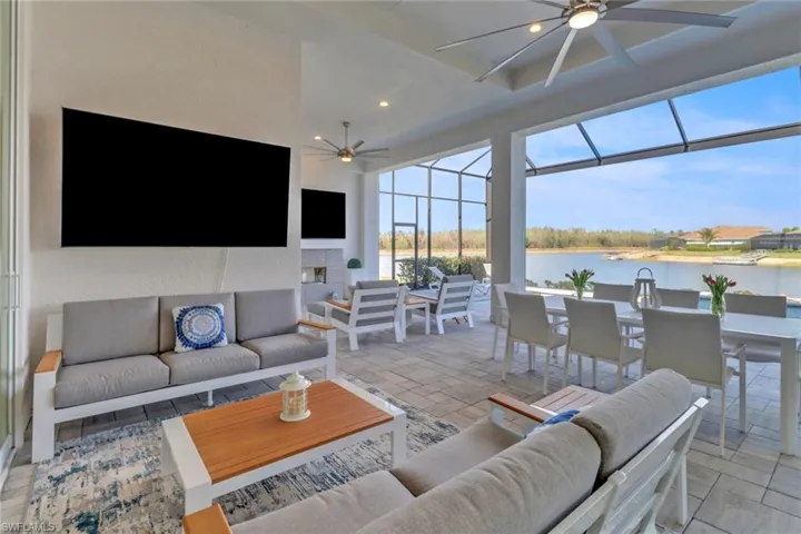 Outdoor Living room with a ceiling fan, recessed lighting, a fireplace, and a sunroom