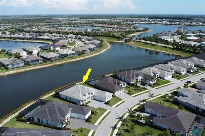 Aerial view of home looking south toward the bridge connecting body of water to large lake.