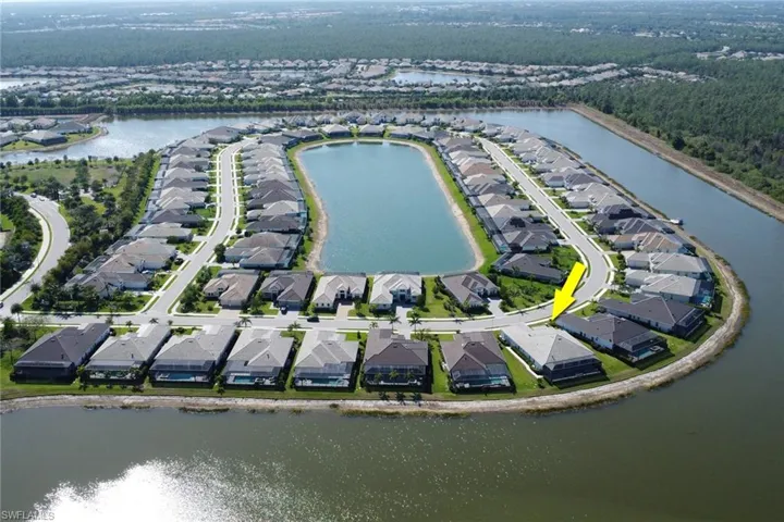 Aerial view of property's location featuring nearby suburban area and a nearby body of water