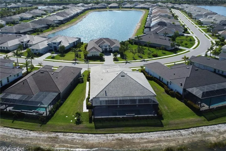 Aerial house form behind with a large body of water across the street.