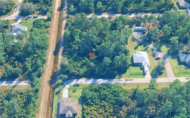 Wooded parcel with established surrounding properties, featuring natural ground cover and mature trees