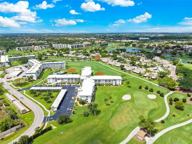 Aerial perspective showcasing the condo building surrounded by the golf course