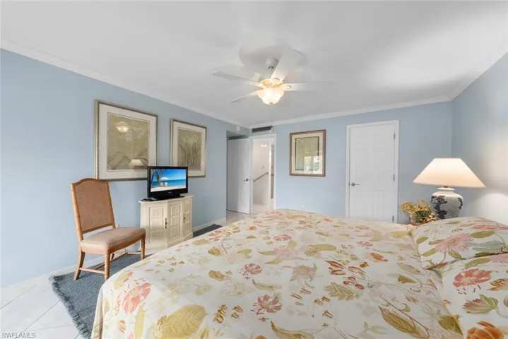 Primary bedroom suite featuring light blue walls, white trim, and a ceiling fan with integrated lighting