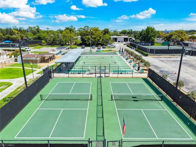 Multiple green-surfaced pickle ball courts with white boundary lines and nets