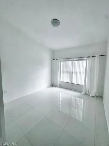Empty room featuring a textured ceiling and baseboards