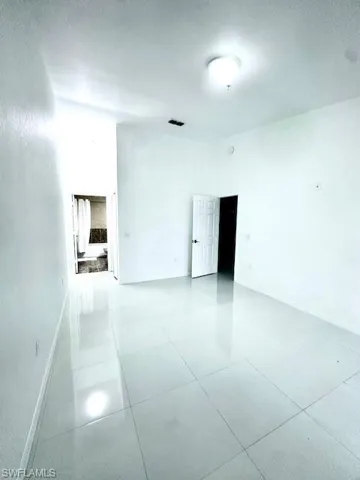Spare room featuring a textured ceiling and a towering ceiling