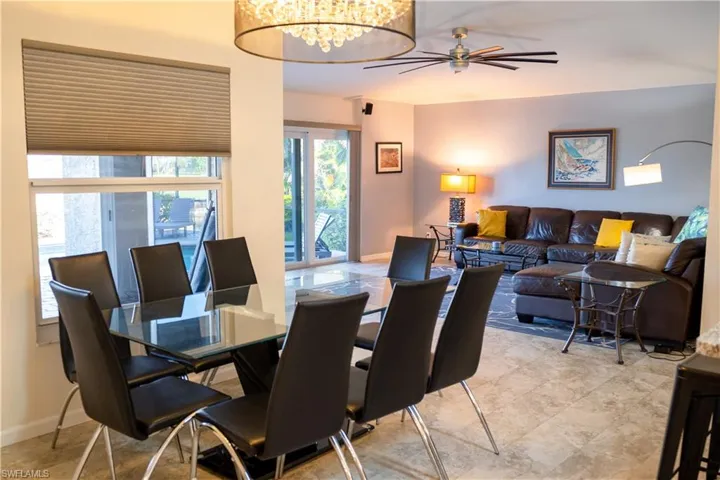 Dining area with baseboards and ceiling fan with notable chandelier