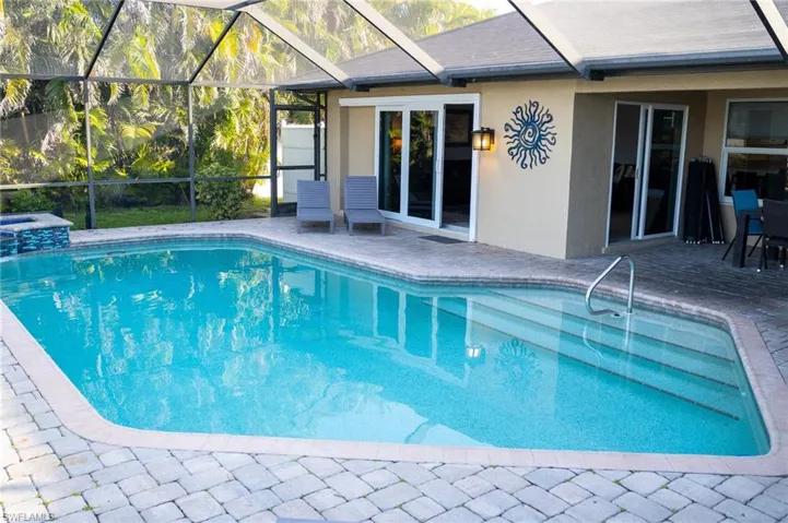 Pool with  enclosure and a patio area