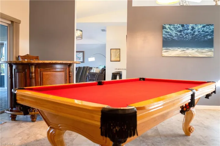 Recreation room featuring baseboards, vaulted ceiling, and pool table