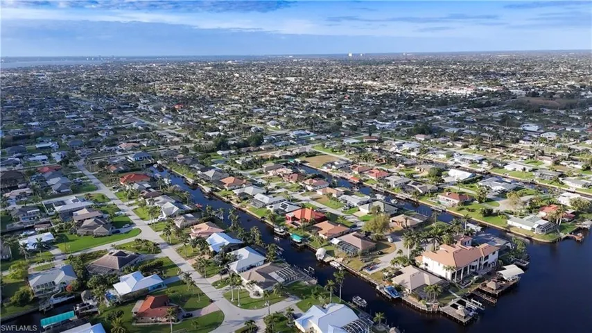 Birds eye view of property with a water view and a residential view