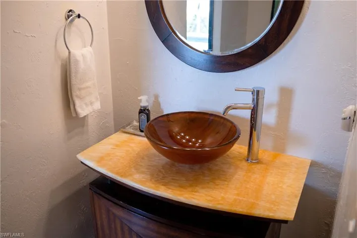 Bathroom featuring vanity and a textured wall