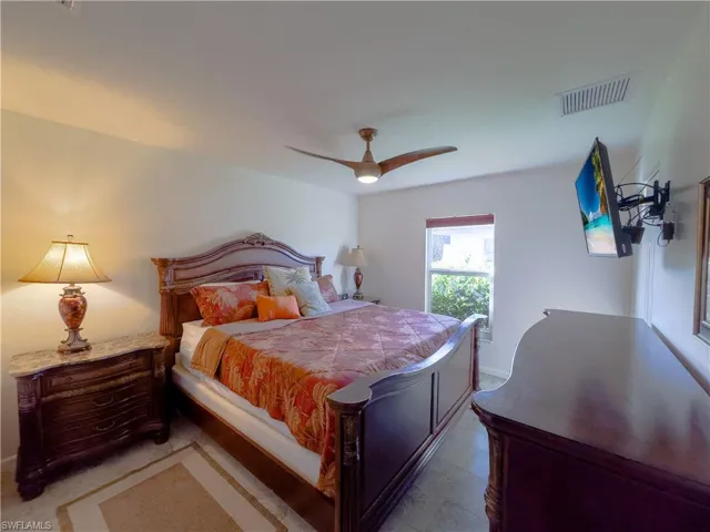 Bedroom with ceiling fan and visible vents