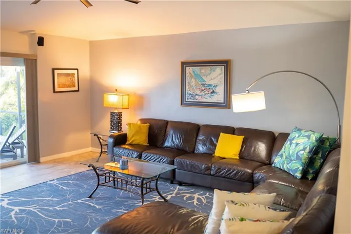 Living room featuring a ceiling fan and baseboards
