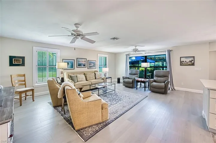 Living area featuring light wood-style floors and a ceiling fan