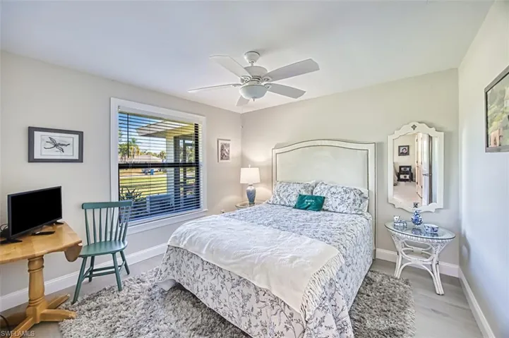 Bedroom with a ceiling fan and light wood-style floors