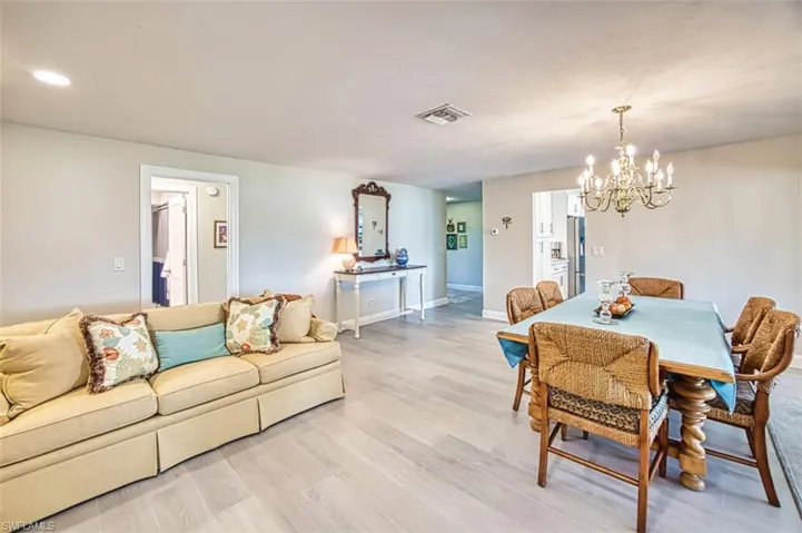 Dining space with light wood-style floors and a chandelier