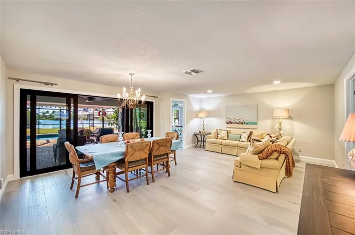 Dining space featuring a chandelier, light wood-style floors, and recessed lighting