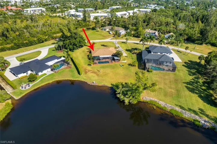 Bird's eye view of a nearby body of water and a tree filled landscape